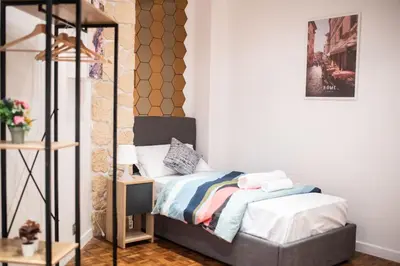 a bedroom with a bed and a mirror at Lusitiny Apartment in Rome