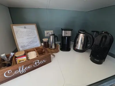 a coffee bar with a coffeemaker and a coffee box on a counter at Benny's House Rome in Rome