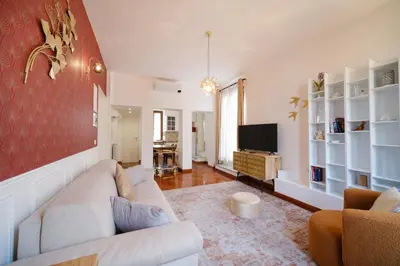 a living room with a couch and a tv at Terrazza Monteverde by BuddyRent in Rome