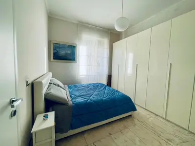 a bedroom with a bed with a blue comforter at Miss Giulia Prime location flat in Rome in Rome