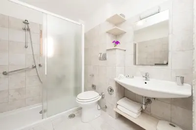 a bathroom with a toilet and a sink and a shower at Foscolo al 24 in Rome