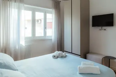 a bedroom with two towels on a bed with a window at Marino's Apartment in Rome