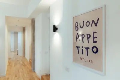 a white room with a sign on the wall at Marino's Apartment in Rome