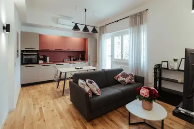 a living room with a couch and a kitchen at Marino's Apartment in Rome