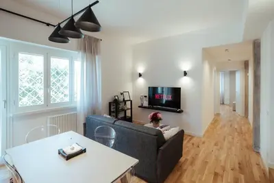 a living room with a couch and a tv at Marino's Apartment in Rome