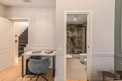 a hallway with a desk and a chair in a room at Maison Della Vite in Rome