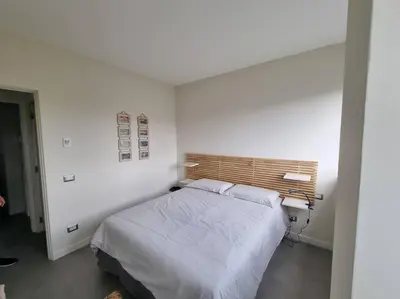 a bedroom with a bed in a white room at La casetta del villaggio - Cozy apartment in Flaminio in Rome