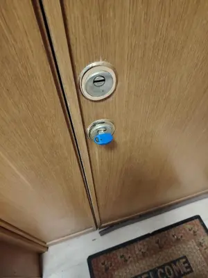 a wooden cabinet with a lock and a button on it at Regina di Cuori in Rome
