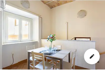 a dining room table with a vase of flowers on it at Appartamento Roma centro 2 da 2 a 4 posti 