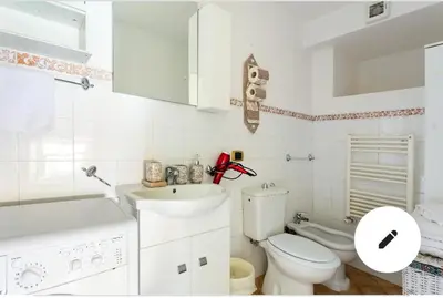 a white bathroom with a toilet and a sink at Appartamento Roma centro 2 da 2 a 4 posti 
