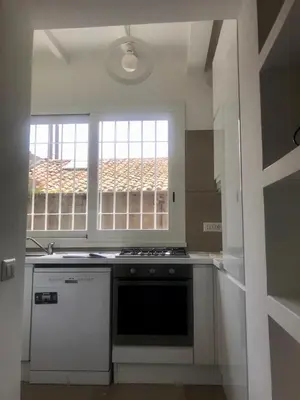 a kitchen with a stove and a window at Domus Antonella a Trastevere in Rome