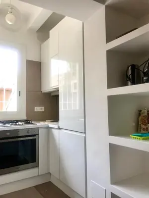 a kitchen with white cabinets and a stove at Domus Antonella a Trastevere in Rome