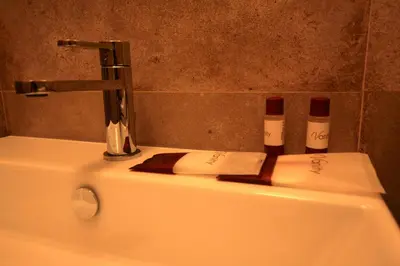 a bathroom sink with two towels and a faucet at Domus Antonella a Trastevere in Rome