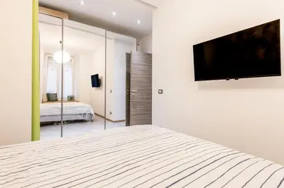 a bedroom with a bed and a television on a wall at Loves Home in Rome