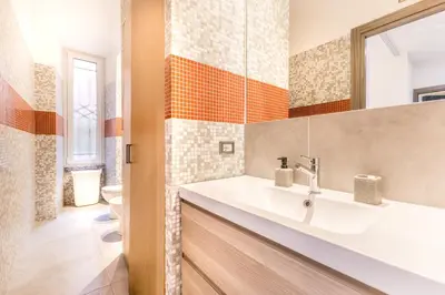a bathroom with a white sink and a mirror at Loves Home in Rome
