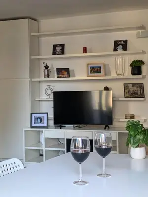 two wine glasses sitting on a table in front of a television at Interno7 in Rome