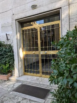 an entrance to a building with a golden door at Interno7 in Rome