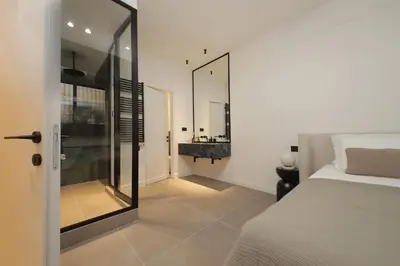 a bedroom with a bed and a bathroom with a mirror at Crispi Loft - My Extra Home in Rome