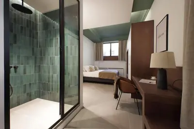 a bathroom with a glass shower and a bedroom at Crispi Loft - My Extra Home in Rome