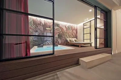 a living room with a large window and a tub at Crispi Loft - My Extra Home in Rome