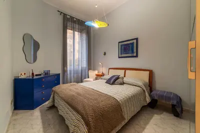 a bedroom with a bed and a blue dresser at GuestHost - Pretty Apartment near Musei Vaticani in Rome
