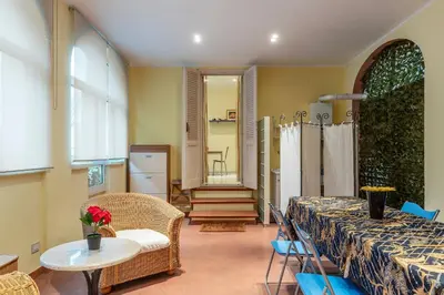 a room with a table and a table and chairs at GuestHost - Pretty Apartment near Musei Vaticani in Rome