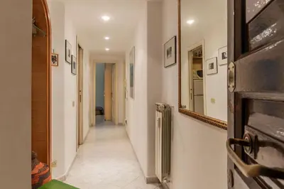 a hallway with a mirror on the wall and a hallwayngthngthngthngthngth at GuestHost - Pretty Apartment near Musei Vaticani in Rome