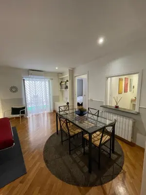 a living room with a glass table and chairs at Lovely Apartment at Saint Peter's Square Vatican in Rome