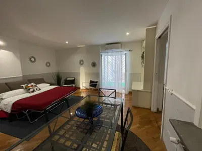a living room with a bed and a glass table at Lovely Apartment at Saint Peter's Square Vatican in Rome