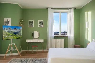 a green bedroom with a bed and a window at Penthouse Lux with Panoramic View in Rome