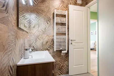 a bathroom with a sink and a wall at Penthouse Lux with Panoramic View in Rome