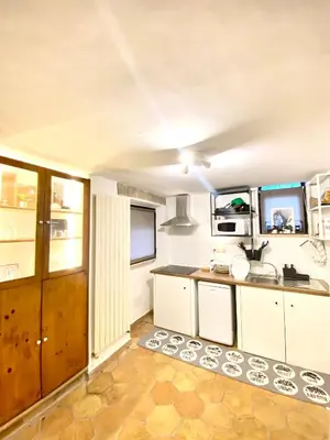 a kitchen with white cabinets and a sink at Dimora Ardeatina in Rome