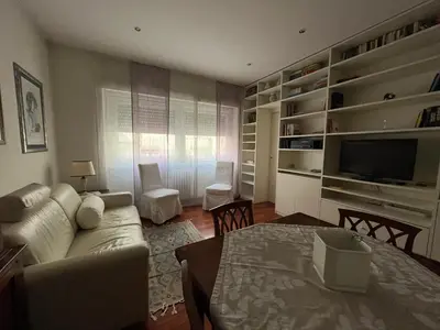 a living room with a couch and a tv and a table at Silvana vatican apartment in Rome