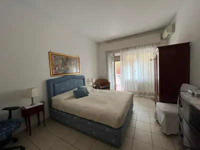 a bedroom with a bed with a blue head board at Silvana vatican apartment in Rome