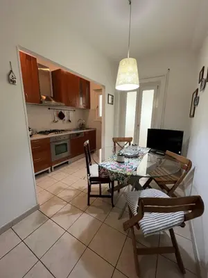 a kitchen and dining room with a table and chairs at Silvana vatican apartment in Rome