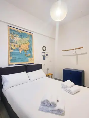 a bedroom with a large white bed with towels on it at Sanpietrino Home in Rome