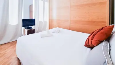 a bedroom with a white bed and a television at Luxury Penthouse with Terrace by Spanish Steps in Rome