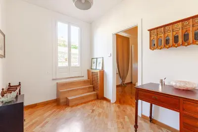 a living room with a staircase and a window at Luxury Penthouse with Terrace by Spanish Steps in Rome