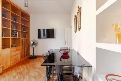 a dining room with a glass table and chairs at Luxury Penthouse with Terrace by Spanish Steps in Rome
