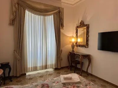 a living room with a table and a tv on the wall at VATICANO Apartment in Rome