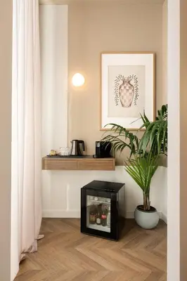 a living room with a potted plant and a shelf at Elegantia Luxury Rooms Trastevere in Rome