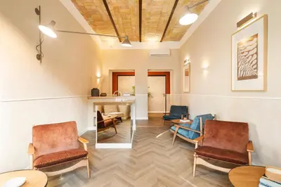 a living room with chairs and a fireplace at Elegantia Luxury Rooms Trastevere in Rome