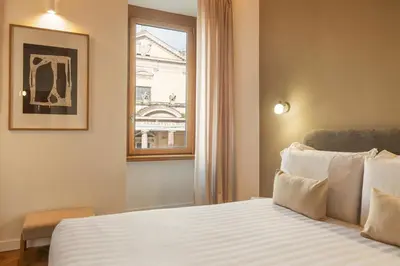 a hotel room with a bed and a window at Elegantia Luxury Rooms Trastevere in Rome