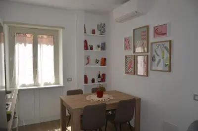 a dining room with a wooden table and chairs at 50 al Vaticano House in Rome