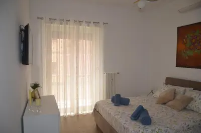 a bedroom with a bed and a large window at 50 al Vaticano House in Rome