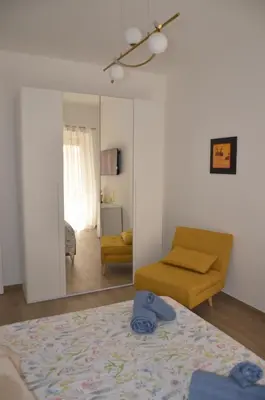 a living room with a bed and a mirror at 50 al Vaticano House in Rome