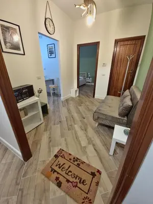 a living room with a welcome sign on the floor at Casa Milly in Rome