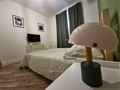 a bedroom with a bed and a lamp on a table at Casa Milly in Rome