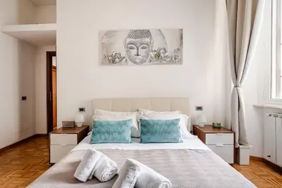 a bedroom with a white bed with towels on it at Suite Testaccio in Rome