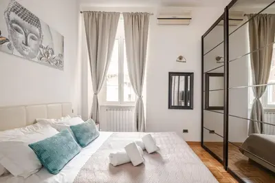 a kitchen with white cabinets and a stove top oven at Suite Testaccio in Rome